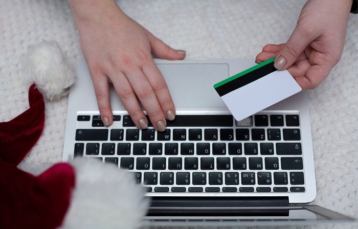 woman making holiday purchase with card