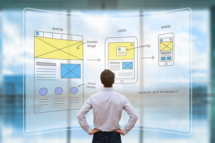 man planning responsive website layouts